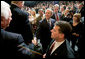 President George W. Bush reaches out to shake the hand of an audience member Monday, April 24, 2006, after addressing the Orange County Business Council in Irvine, Calif. White House photo by Eric Draper