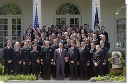 President George W. Bush poses with the United States Naval Academy football team during the presentation of the Commander-in-Chief Trophy in the Rose Lawn April 25, 2006. "Seniors on this team have lead one of the most dramatic turn-arounds in college football history," said the President. "Navy has won 26 games in the past three seasons after winning just three games during the previous three years. The seniors are the sixth class in Academy history to have beaten Army all four years." White House photo by Kimberlee Hewitt