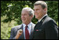 President George W. Bush sports an oversized championship ring as the stands with Midshipman Jeremy Chase of the United States Naval Academy football team during the presentation of the Commander-in-Chief Trophy to in the Rose Lawn April 25, 2006. White House photo by Paul Morse