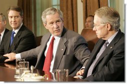 President George W. Bush places his hands on the arm of U.S. Senate Majority leader Senator Bill Frist, R-Tenn., left, and U.S. Senate Democratic leader Senator Harry Reid, D-Nev., right, at the conclusion of a meeting with legislators Tuesday, April 25, 2006 at the White House to discuss immigration reform. President Bush thanked both Republican and Democratic members of the Senate for their hard work to get a comprehensive immigration bill out of the U.S. Senate and hopefully to his desk before the end of this year.  White House photo by Eric Draper