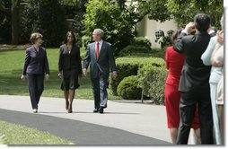 President George W. Bush and Mrs. Laura Bush accompany 2006 National Teacher of the Year Kim Oliver to the South Lawn ceremony in her honor Wednesday, April 26, 2006. Said the President of the Silver Spring, Maryland kindergarten teacher, "Kim Oliver understands that the key to helping children succeed is fighting the soft bigotry of low expectations." White House photo by Paul Morse