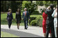 President George W. Bush and Mrs. Laura Bush accompany 2006 National Teacher of the Year Kim Oliver to the South Lawn ceremony in her honor Wednesday, April 26, 2006. Said the President of the Silver Spring, Maryland kindergarten teacher, "Kim Oliver understands that the key to helping children succeed is fighting the soft bigotry of low expectations." White House photo by Paul Morse