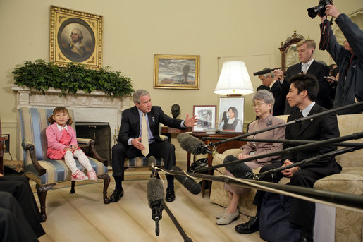 President George W. Bush addresses the press during a meeting with a family of North Korean defectors and family members of Japanese citizens who were abducted by the North Korean government in the Oval Office Friday, April 28, 2006. Kim Han-Mee, the daughter of North Korean defectors, sat next to the President. White House photo by Paul Morse