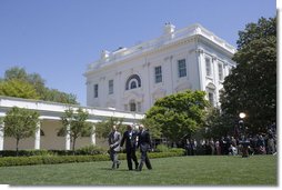 President George W. Bush walks across the Rose Garden with Al Hubbard of the National Economic Council, left, and Ed Lazear of the Council of Economic Advisors, after addressing the press Friday, April 28, 2006.  White House photo by Paul Morse