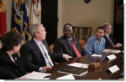 President George W. Bush meets with Darfur advocates, including former slave Simon Deng, in the Roosevelt Room Friday, April 28, 2006. "I just had an extraordinary conversation with fellow citizens from different faiths, all of who have come to urge our government to continue to focus on saving lives in Sudan," said the President to the press. "They agree with thousands of our citizens -- hundreds of thousands of our citizens -- that genocide in Sudan is unacceptable." White House photo by Paul Morse