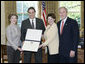 President George W. Bush and Mrs. Bush present the Preserve America award for private preservation to Judy Christa-Cathey, Vice President Brand Management, and Scott Douglas Schrank, Vice President Brand Performance and Support, both of Hampton Hotels' nationwide Save-A-Landmark program, in the Oval Office Monday, May 1, 2006. White House photo by Eric Draper