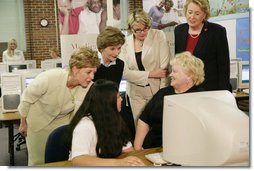 Mrs. Laura Bush and U.S. Department of Education Secretary Margaret Spellings, center, look at computer information with St. Boniface sixth-graders and senior citizens Tuesday, May 2, 2006 in Ft. Smith, Ark., to remind seniors of the May 15th enrollment deadline to sign-up for the Medicare Prescription Drug Benefit. White House photo by Shealah Craighead