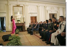 President George W. Bush and guests listen to artist Graciela Beltran perform during the White House celebration of Cinco De Mayo in the East Room Thursday, May 4, 2006. White House photo by Paul Morse