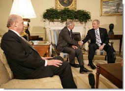 President George W. Bush shakes the hand of Porter Goss Friday, May 5, 2006, in the Oval Office after the Director of the Central Intelligence Agency announced his resignation. The President thanked him for his service and said of Director Goss, "He honors the proud history of the CIA." Looking on is Ambassador John Negroponte, Director of National Intelligence. White House photo by Eric Draper