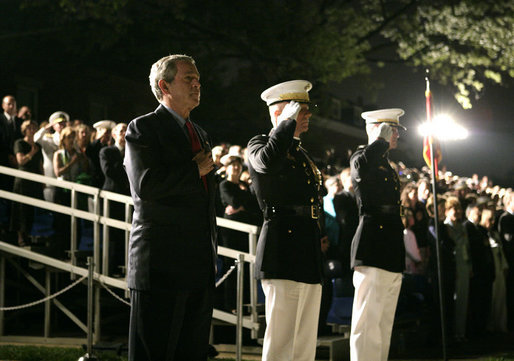 President George W. Bush stands at attention Friday, May 5, 2006, during an Evening Parade at the Marine Barracks in Washington, D.C. The President and Mrs. Laura Bush spent the evening meeting with U.S. Marine Corps Noncommissioned Officers of the Year and wounded Marines. White House photo by Paul Morse