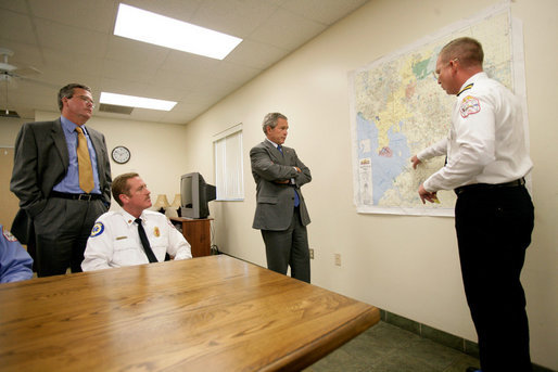 President George W. Bush and Florida Governor Jeb Bush receive a briefing on brush fires at the Hillsborough County Fire Station in Sun City Center, Florida, Tuesday, May 9, 2006. White House photo by Eric Draper