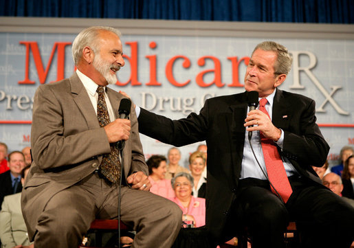 President George W. Bush speaks with retired senior Peter Navarro during A Conversation on the Medicare Prescription Drug Benefit at the Asociacion Borinquena de Florida Central, Inc., in Orlando Wednesday, May 10, 2006. White House photo by Eric Draper