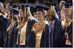 A student stands for the playing of the national anthem during the commencement ceremonies at Mississippi Gulf Coast Community College in Biloxi, Miss., Thursday, May 11, 2006. "You have sent a message and I came with a message of my own: This nation honors your dedication," said the President of the students' determination to graduate and help each other after Hurricane Katrina. "We're inspired by your optimism, and we'll help this great state of Mississippi rebuild." White House photo by Paul Morse