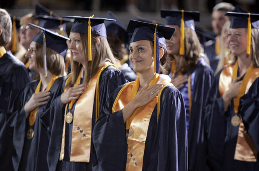 A student stands for the playing of the national anthem during the commencement ceremonies at Mississippi Gulf Coast Community College in Biloxi, Miss., Thursday, May 11, 2006. "You have sent a message and I came with a message of my own: This nation honors your dedication," said the President of the students' determination to graduate and help each other after Hurricane Katrina. "We're inspired by your optimism, and we'll help this great state of Mississippi rebuild." White House photo by Paul Morse