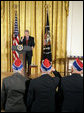 President George W. Bush salutes veterans during an event celebrating Asian Pacific American Heritage Month in the East Room Friday, May 12, 2006. "These men and women are on the front line of defending the United States of America, and in so doing, they're laying the foundation of peace for generations to come. And we're really proud of your service," said the President. White House photo by Paul Morse