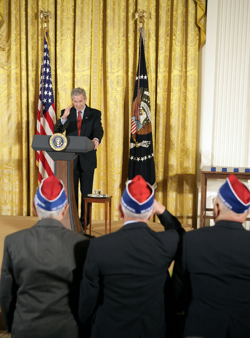 President George W. Bush salutes veterans during an event celebrating Asian Pacific American Heritage Month in the East Room Friday, May 12, 2006. "These men and women are on the front line of defending the United States of America, and in so doing, they're laying the foundation of peace for generations to come. And we're really proud of your service," said the President. White House photo by Paul Morse