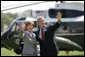 President George W. Bush and Mrs. Laura Bush wave to guests on the South Lawn Friday, May 12, 2006, before boarding Marine One en route Camp David. White House photo by Eric Draper