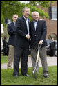 President George W. Bush and Australian Prime Minister John Howard shake hands during the presentation of White House tress at the Australian Ambassador's Residence, Sunday, May 14, 2006. White House photo by Eric Draper