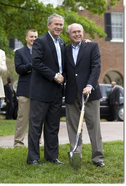 President George W. Bush and Australian Prime Minister John Howard shake hands during the presentation of White House tress at the Australian Ambassador's Residence, Sunday, May 14, 2006. White House photo by Eric Draper