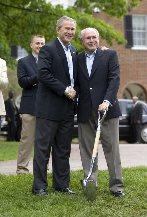 President George W. Bush and Australian Prime Minister John Howard shake hands during the presentation of White House tress at the Australian Ambassador's Residence, Sunday, May 14, 2006. White House photo by Eric Draper