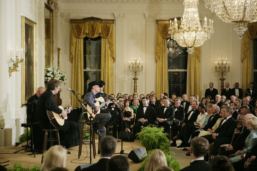 President George W. Bush, Mrs. Laura Bush and their invited guests listen to country singer Kenny Chesney perform in the East Room of the White House Tuesday evening, May 16, 2006, at the official dinner for Australian Prime Minister John Howard and Mrs. Janette Howard. White House photo by Paul Morse