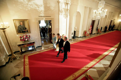 President George W. Bush and Laura Bush walk with Australian Prime Minister John Howard and his wife Mrs. Janette Howard through the Cross Hall as they arrive for the official dinner held in honor of the Prime Minister Tuesday, May 16, 2006. White House photo by Eric Draper