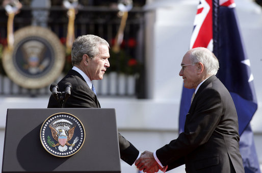 After delivering his remarks, President George W. Bush shakes hands with Australian Prime Minister John Howard during the State Arrival Ceremony held for the Prime Minister on the South Lawn Tuesday, May 16, 2006. "Freedom has enemies, and for more than a hundred years, Australians and Americans have joined together to defend freedom," said President Bush. "Together we fought the Battle of Hamel in World War I. Together we fought in World War II from the beaches of Normandy to the waters of the Coral Sea. Together we fought in Korea and Vietnam. And together we're fighting, and winning, the global war on terror." White House photo by Paul Morse