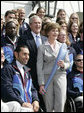 President George W. Bush and Laura Bush, seen holding an Olympic torch, pose with the 2006 U.S. Winter Olympic and Paralympic teams during a congratulatory ceremony held on the South Lawn at the White House Wednesday, May 17, 2006. White House photo by Eric Draper