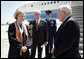 Upon landing in Louisana, Vice President Dick Cheney talks with Louisiana State University Student Body President Michelle Gieg and Chancellor Sean O'Keefe alongside Air Force Two. The vice president delivered the commencement address to over 3,000 bachelors, masters, and doctoral students. White House photo by David Bohrer