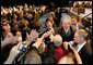 President George W. Bush greets the audience, Monday, May 22, 2006, following his remarks on the War on Terror to the National Restaurant Association gathering at Chicago's McCormick Place. White House photo by Eric Draper