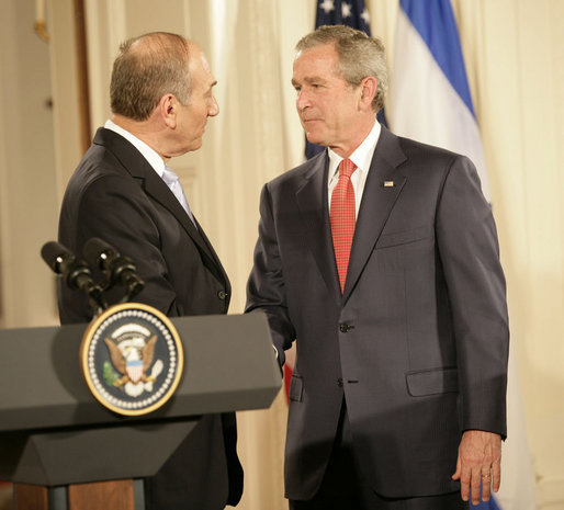 President George W. Bush and Prime Minister Ehud Olmert of Israel exchange handshakes Tuesday, May 23, 2006, at the end of a joint press availability in the East Room of the White House. White House photo by Eric Draper