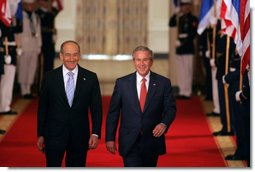 President George W. Bush walks through the Cross Hall with Prime Minister Ehud Olmert of Israel to a joint press conference in the East Room Tuesday, May 23, 2006.  White House photo by Kimberlee Hewitt