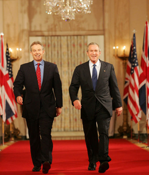 President George W. Bush and Prime Minister Tony Blair of Great Britain, walk through Cross Hall en route to the East Room Thursday night, May 25, 2006, for a joint press availability during which the President said of Iraq's new government, "The United States and Great Britain will work together to help this new democracy succeed." White House photo by Shealah Craighead