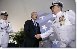 President George W. Bush congratulates Admiral Tom Collins for his 38 years of service in the U.S. Coast Guard, including the last four as Commandant, during the U.S. Coast Guard's Change of Command Ceremony Thursday, May 25, 2006, at Fort Lesley J. McNair in Washington, D.C. Looking on is Admiral Collins' successor, Admiral Thad Allen. White House photo by Eric Draper