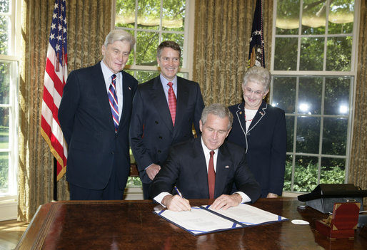 President George W. Bush is joined by Senator John Warner, R-Va, left, Senator Bill Frist, R-TN, center, and Congresswoman Virginia Foxx, R-NC, as he signs H.R. 1499, the Heroes Earned Retirement Opportunities Act, in the Oval Office Monday, May 29, 2006. White House photo by Paul Morse