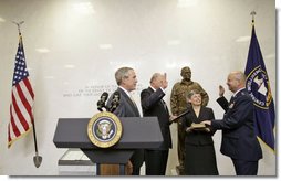 President George W. Bush attends the swearing-in of Gen. Michael Hayden as the Director of the Central Intelligence Agency by Director of National Intelligence John Negroponte at CIA Headquarters in Langley, Va., Wednesday, May 31, 2006. Pictured holding the Bible is Gen. Hayden's wife Jeanine Hayden. White House photo by Eric Draper