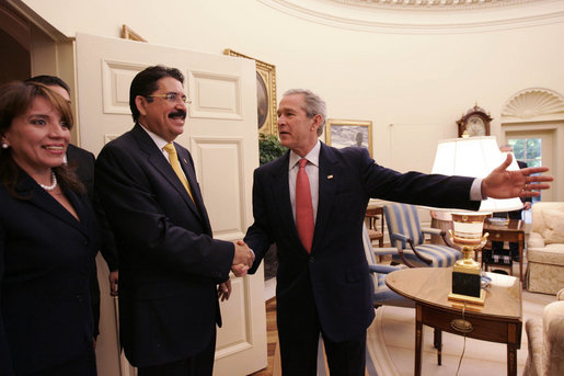 President George W. Bush welcomes President Manuel Zelaya and First Lady of Honduras, Xiomora Zelaya, to the Oval Office Monday, June 5, 2006. "We've had a very good discussion, as you would expect amongst friends," said President Bush. "We discussed our common interests, and one of our common interests is expanded commercial opportunity. And CAFTA gives us a chance to realize those opportunities. We talked about our common desire to make sure the democracies in the region are strong." White House photo by Eric Draper