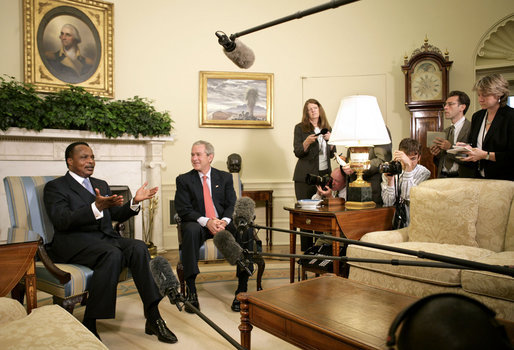 President George W. Bush and President Denis Sassou-Nguesso of the Republic of the Congo talk with the press during a meeting in the Oval Office Monday, June 5, 2006. "We had a very constructive discussion about a variety of issues," said President Bush. "We talked about our common commitment to help end the genocide in Darfur. I appreciate the President's leadership in helping negotiate a peace agreement, and I appreciate his leadership in working with the United Nations so we can get the AU forces blue-helmeted as quickly as possible." White House photo by Eric Draper