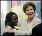 Mrs. Laura Bush congratulates Our Lady of Perpetual Help School student Rajanique White, 10, Monday, June 5, 2006, for the story Rajanique wrote and recited about a small accident that happened to her. Mrs. Bush visited the school to announce a Laura Bush Foundation for America’s Libraries grant to Our Lady of Perpetual Help. White House photo by Shealah Craighead