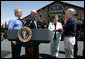 President George W. Bush stands with U.S.Homeland Security Secretary Michael Chertoff during the swearing-in ceremony of W. Ralph Basham, right, as the new Commissioner for U.S. Customs and Border Protection, Tuesday, June 6, 2006 at the Federal Law Enforcement Training Center Artesia Facility in Artesia, New Mexico. Commissioner Basham's wife, Judy Basham, holds the Bible during the ceremony. White House photo by Eric Draper