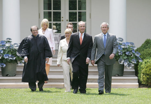 President George W. Bush walks with former Idaho Gov. Dirk Kempthorne prior to his swearing-in ceremony as the new U.S. Secretary of Interior by Supreme Court Justice Antonin Scalia, left, Wednesday, June 7, 2006 on the South Lawn of the White House in Washington. Patricia Kempthorne, center, who held the Bible during her husband’s swearing-in, is joined by their children Heather Myklegard and son, Jeff Kempthorne. White House photo by Kimberlee Hewitt