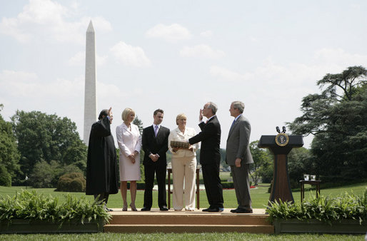 President George W. Bush stands with former Idaho Gov. Dirk Kempthorne as he is sworn-in as the new U.S. Secretary of Interior by Supreme Court Justice Antonin Scalia, left, Wednesday, June 7, 2006 on the South Lawn of the White House in Washington. Patricia Kempthorne holds the Bible during her husband’s swearing-in, joined by their children Heather Myklegard and son, Jeff Kempthorne. White House photo by Kimberlee Hewitt