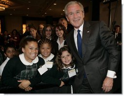 President George W. Bush poses with a group of young children Thursday morning, June 8, 2006, following his address at the National Hispanic Prayer Breakfast in Washington. White House photo by Kimberlee Hewitt