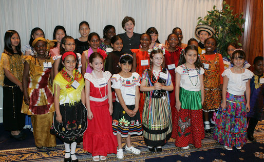 Mrs. Laura Bush poses with members of the St. Catherine Laboure School’s Cultural Hertiage Choir, Thursday, June 8, 2006 at the President’s Malaria Initiative conference at the National Press Club in Washington. The choir, dressed in heritage costumes, consists of students from first grade to eighth grade representing 20 nations. White House photo by Shealah Craighead