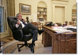 President George W. Bush talks with Prime Minister Nouri al-Maliki of Iraq regarding the death of terrorist al Zarqawi from the Oval Office Thursday morning, June 8, 2006.  White House photo by Eric Draper