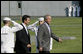 President George W. Bush escorts Prime Minister Anders Fogh Rasmussen of Denmark pass a U.S. Navy Honor Guard at Camp David Friday, June 9, 2006. Prime Minister Rasmussen and members of his family are visiting Camp David as guests of President Bush and Mrs. Laura Bush. White House photo by Eric Draper