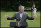 President George W. Bush gestures as he answers a reporter's question during his joint news conference with Prime Minister Anders Fogh Rasmussen of Denmark at Camp David Friday, June 9, 2006. White House photo by Eric Draper