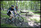 President George W. Bush and Prime Minister Anders Fogh Rasmussen of Denmark navigate a path at Camp David Friday, June 9, 2006. White House photo by Eric Draper