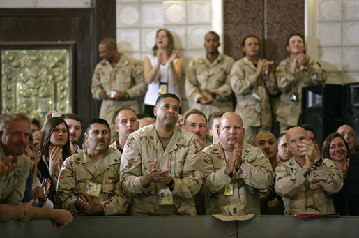 U.S. troops listen to President George W. Bush speak during his an 5-hour trip to Baghdad, Iraq, Tuesday, June 13, 2006. "I have come today to personally show our nation's commitment to a free Iraq. My message to the Iraqi people is this: seize the moment; seize this opportunity to develop a government of and by and for the people. And I also have a message to the Iraqi people that when America gives a commitment, America will keep its commitment." White House photo by Eric Draper