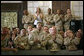 U.S. troops listen to President George W. Bush speak during his an 5-hour trip to Baghdad, Iraq, Tuesday, June 13, 2006. "I have come today to personally show our nation's commitment to a free Iraq. My message to the Iraqi people is this: seize the moment; seize this opportunity to develop a government of and by and for the people. And I also have a message to the Iraqi people that when America gives a commitment, America will keep its commitment." White House photo by Eric Draper